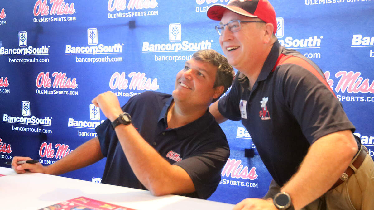 Ole Miss football coach Matt Luke poses for a photo with Tony Goretski of Long Beach during the Rebel Road Trip stop at the Great Southern Club in Gulfport on Monday, April 23, 2018.