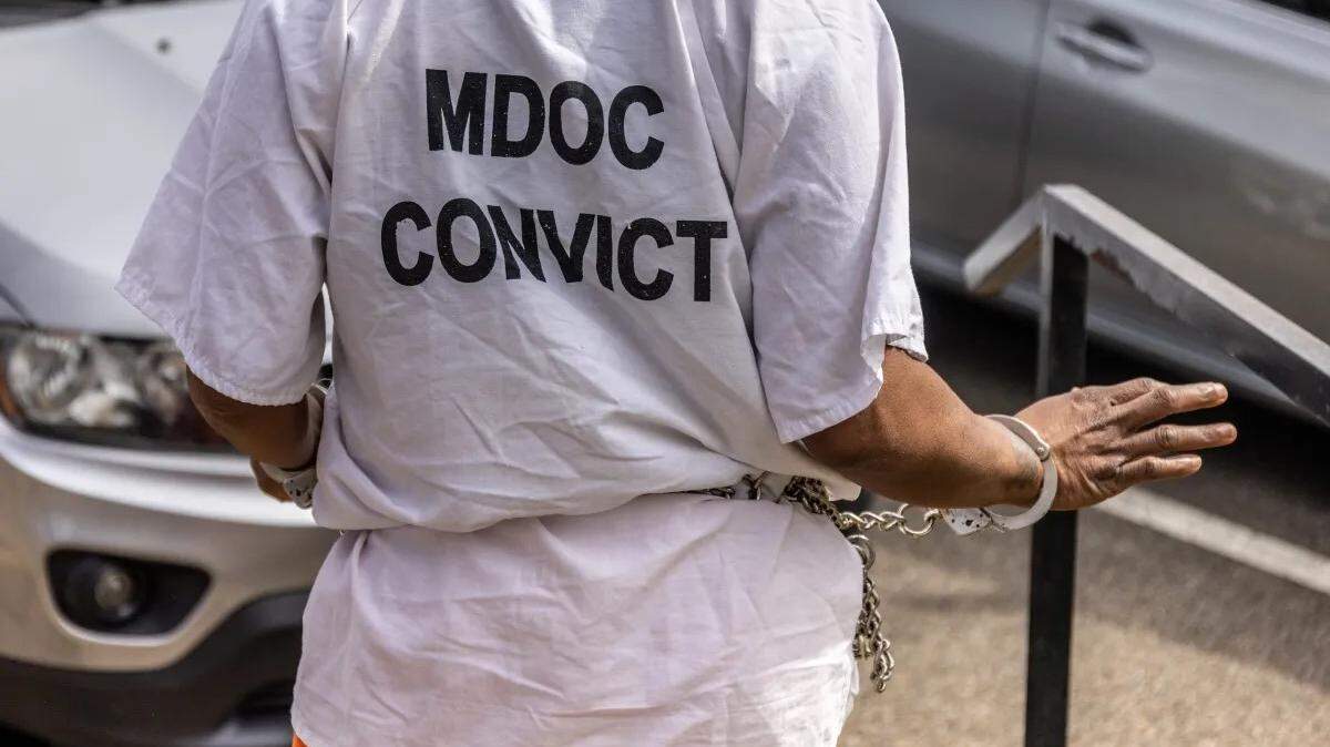A woman going through the civil commitment process, wearing a shirt labeling her a “convict,” is transported from her commitment hearing back to a county jail to await transportation to a state hospital in north Mississippi last spring.