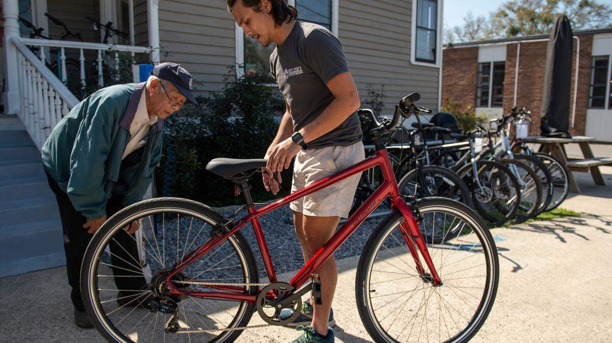 Sinh Nguyen, 76, left, inspects his new bike with Adam Nguyen, 25, service manager at Biloxi Bicycle Works on Wednesday, Feb. 23, 2022. The bike was gifted to Sinh, who relies on a bike since his vision prohibits him from driving, after a GoFundMe campaign to raise the money for the bike.