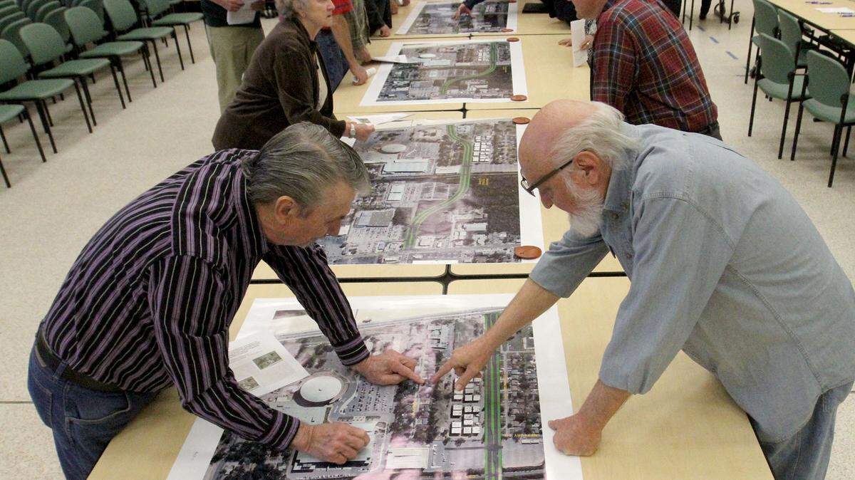 JOHN FITZHUGH/SUN HERALDOakmont Place homeowners Wilbur Maddox, left, and Harold Sumners look at maps during a drop-in meeting on the proposed Popps Ferry Road extension routes at the Donal Snyder Community Center in Biloxi on Tuesday March 22, 2016.