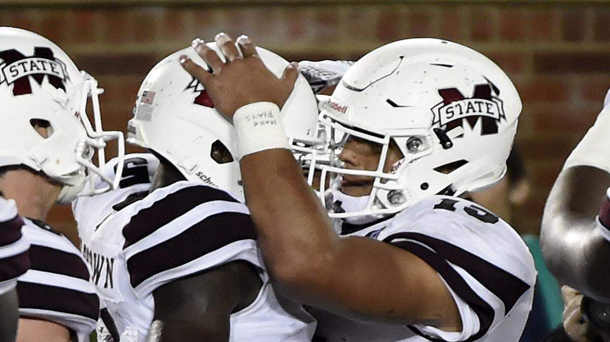 L.G. PATTERSON/ASSOCIATED PRESS 
 Mississippi State quarterback Dak Prescott, right, and wide receiver Fred Brown celebrate after Brown caught an eight-yard touchdown pass from Prescott.