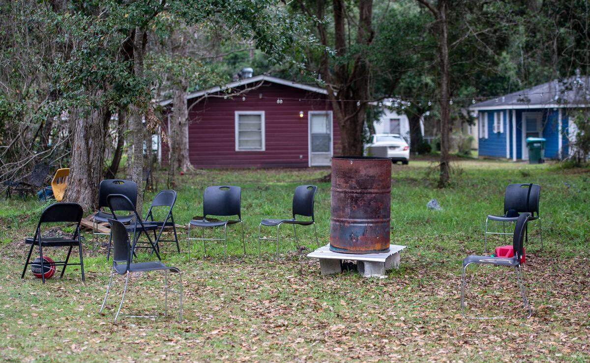 Chairs sit around a makeshift fire pit from a party on a property on Lewis Avenue in the Gaston Point community in Gulfport, the site of a New Years’ Eve shooting that killed three, on Saturday, Jan. 1, 2021.