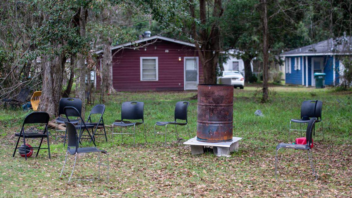 Chairs sit around a makeshift fire pit from a party on a property on Lewis Avenue in the Gaston Point community in Gulfport, the site of a New Years’ Eve shooting that killed three, on Saturday, Jan. 1, 2021.