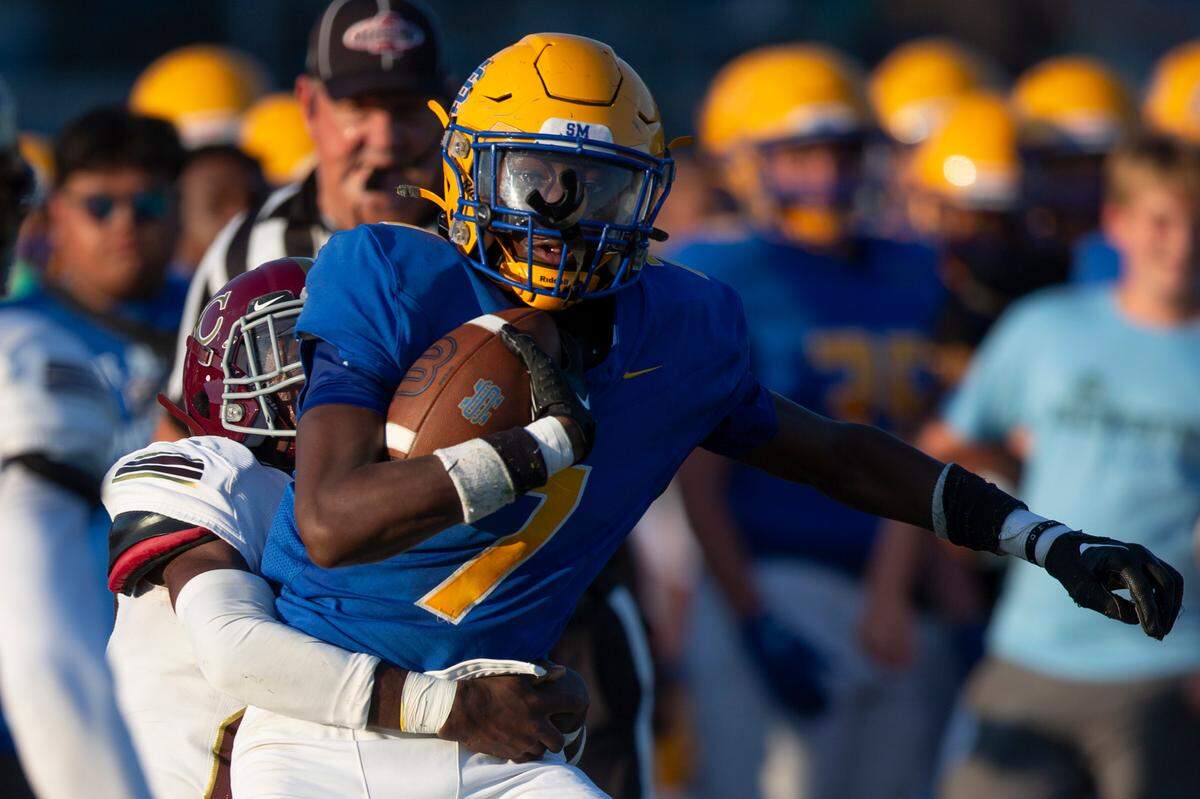 St. Martin’s Monclair Brave (#7) gets tackled as he runs the ball during a Jamboree game against George County at St. Martin High School in Ocean Springs on Friday, Aug. 23, 2024.