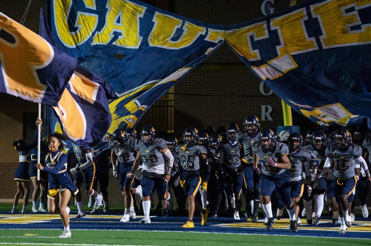 The Gautier Gators run out onto the field before a 5A playoff game between Gautier and Natchez at Gautier High School on Friday, Nov. 15, 2024.