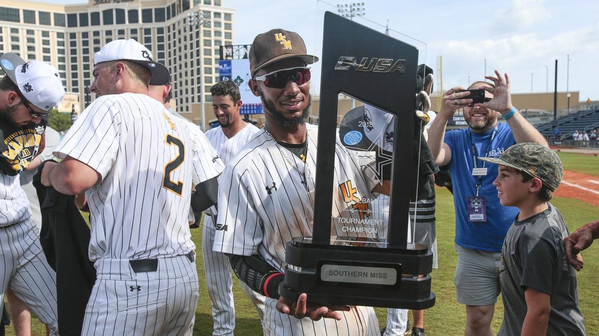 Southern Miss shortstop Leemarcus Boyd holds up the trophy after USM beat FAU on May 27, 2018, at MGM Park in Biloxi.