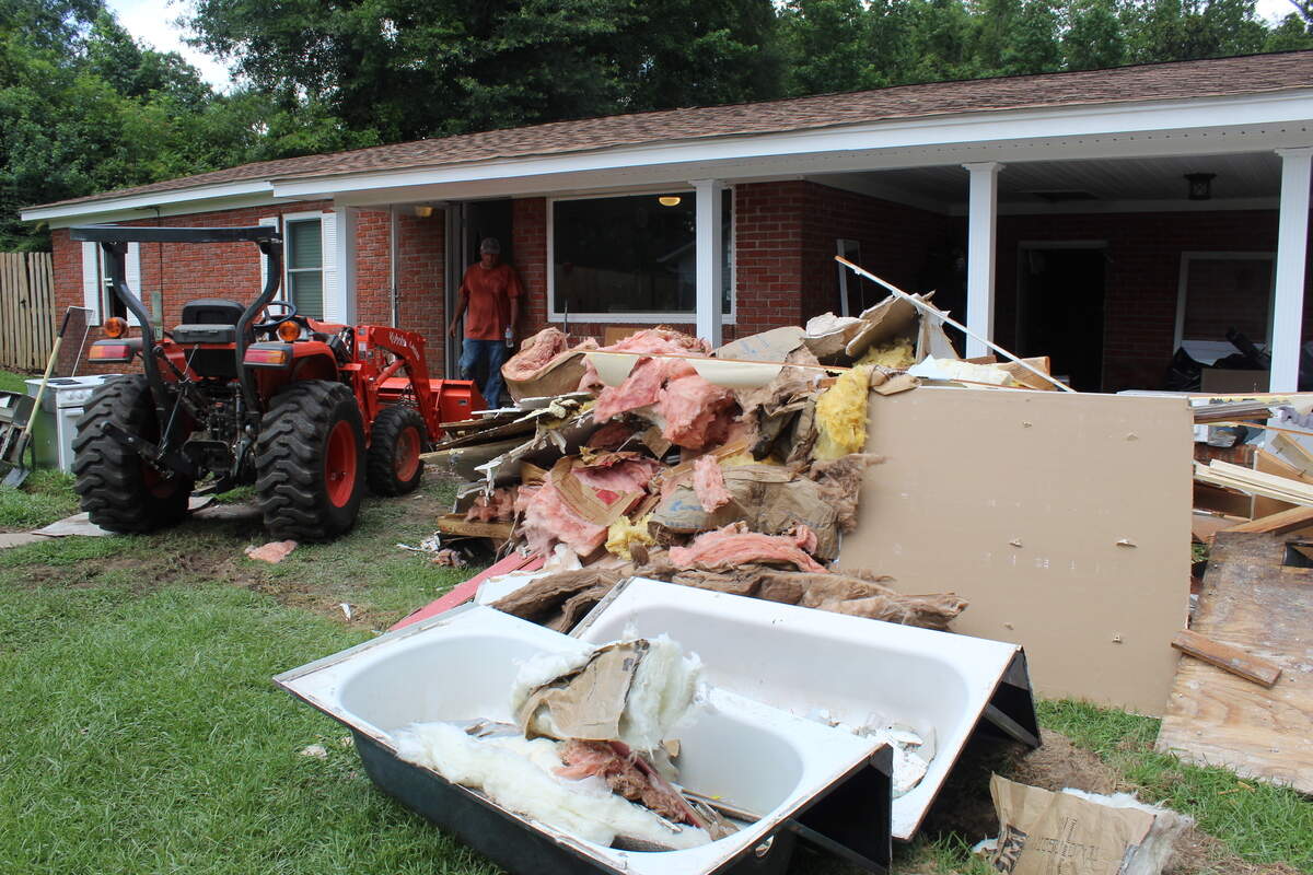 Volunteers from The Potter’s House Ministry assist in clean-up efforts in Perkinston on June 24.