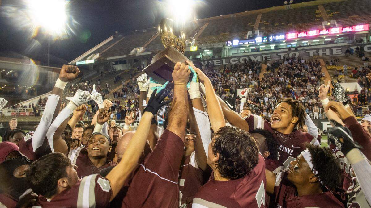 The Picayune Maroon Tide hoist a trophy in the air, celebrating their the 5A State Championship game win over West Point at M.M. Roberts Stadium in Hattiesburg on Saturday, Dec. 4, 2021.
