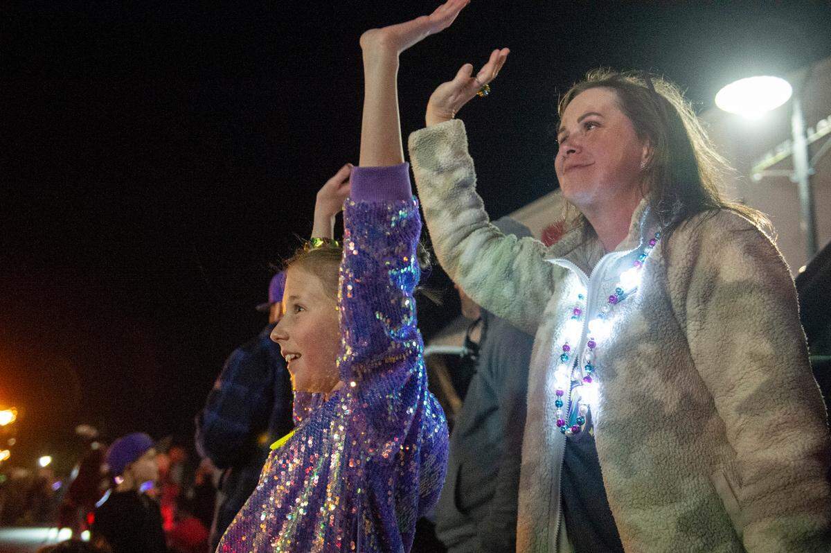Paradegoers cheer for beads during Mystic Krewe of the Seahorse’s Lundi Gras parade in Bay St. Louis on Monday, March 3, 2025.