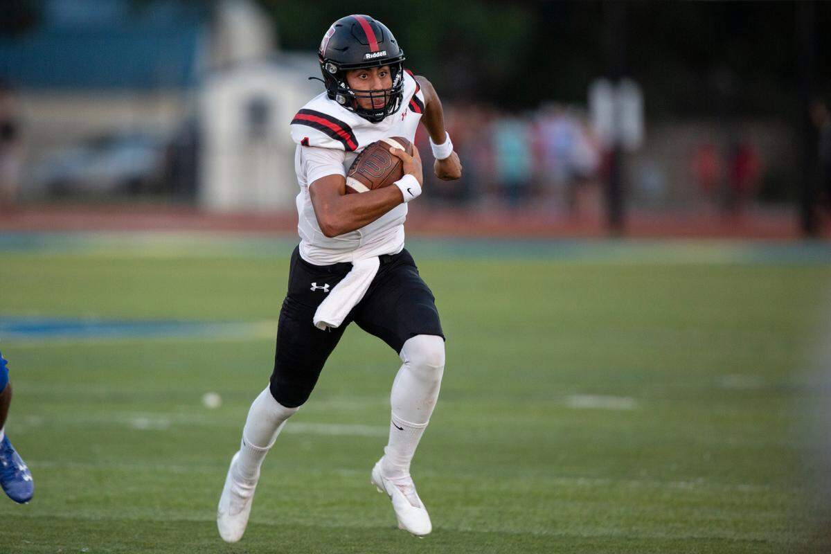 St. Stanislaus quarterback Ian Gael Gonzalez Rioz runs the ball during a game at Bay High in Bay St. Louis on Friday, Sept. 1, 2023.