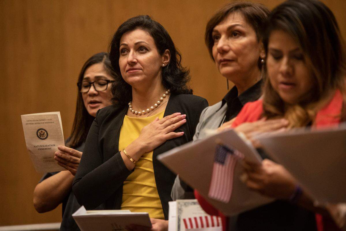 New American citizens sing the star spangled banner during a naturalization ceremony at Dan M. Russell Jr. Federal Courthouse in Gulfport on Friday, Oct. 7, 2022.