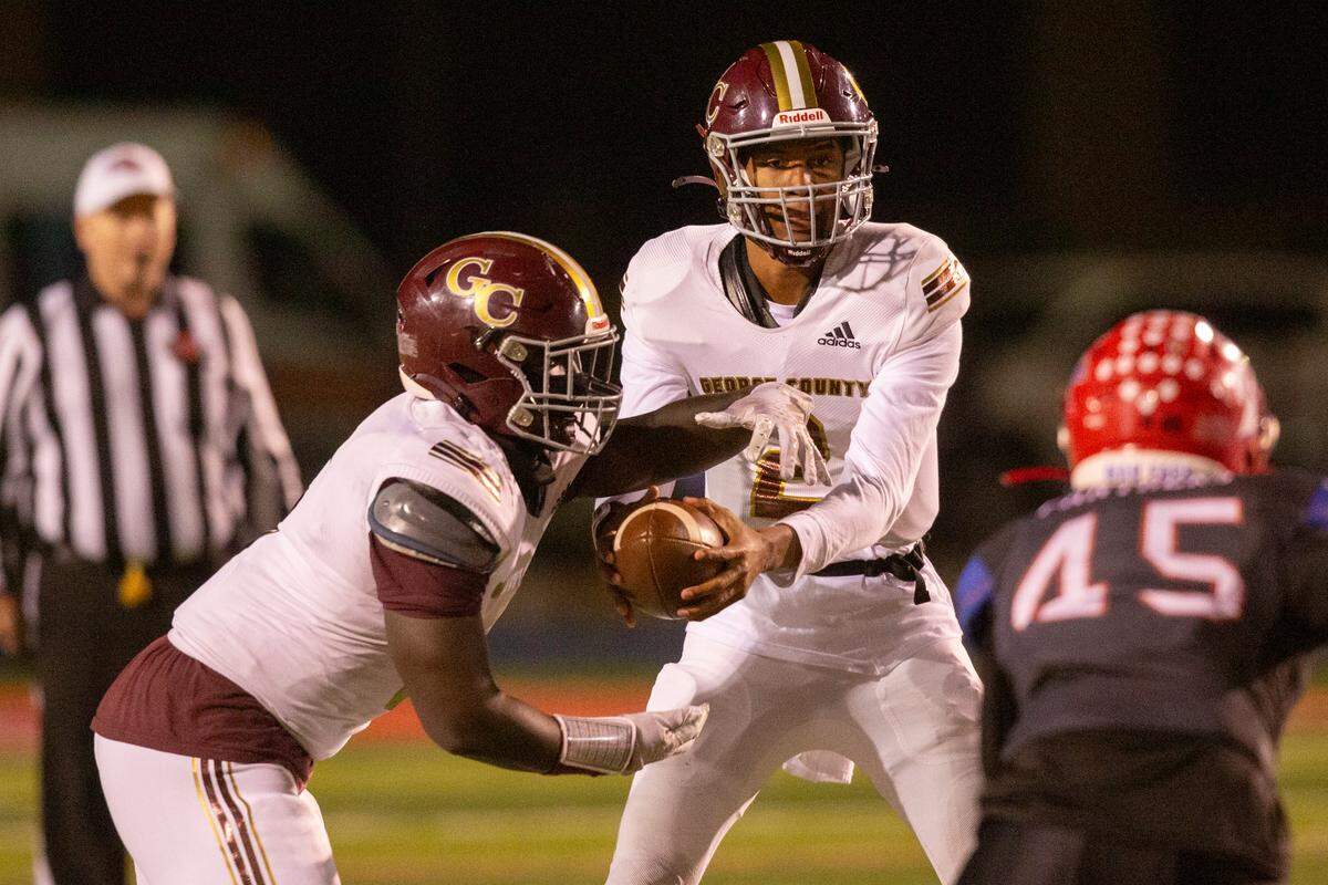 George County quarterback Deuce Knight hands the ball off during a game against Pascagoula at Pascagoula High in Pascagoula on Thursday, Nov. 2, 2023.