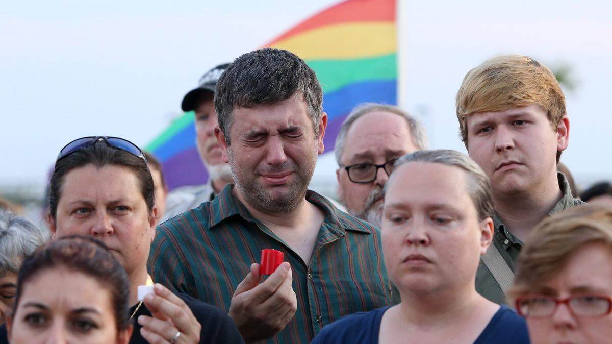 JOHN FITZHUGH/SUN HERALDDrew Landry-Rester of Wiggins cries as names of the victims of the mass shooting in Orlando are read during a vigil near the lighthouse in Biloxi on Monday to honor the victims.