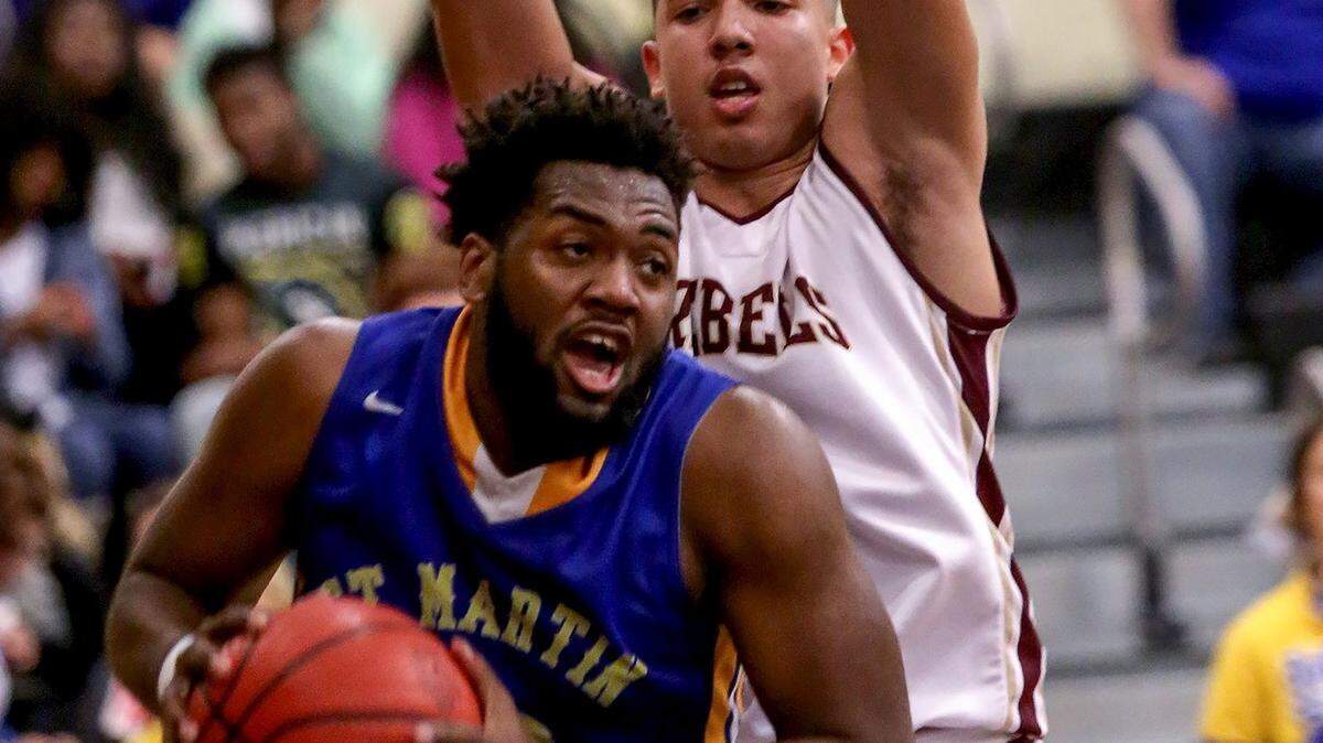 AMANDA McCOY/SUN HERALD 
 St. Martin's Jonte Moultrie drives past George County's Tyrese Fryfogle on Friday at D'Iberville High. George County defeated St. Martin 64-58 to win the Region 7-6A championship. St. Martin hosts Harrison Central at 7 p.m. Tuesday.