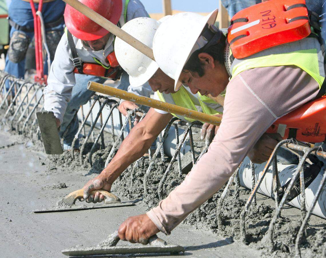 Workers smooth the newly poured concrete on the Popp’s Ferry Road bridge in Biloxi in 2009. The bridge was repaired and open three days ahead of schedule.