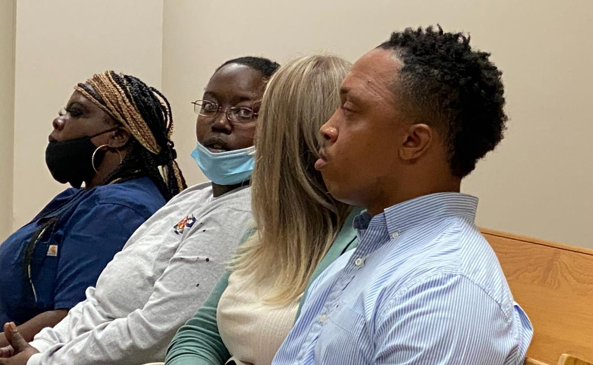 Ex-Moss Point police Officer Eric Maye sits with family and friends in Jackson County Circuit court prior to his arrest Monday