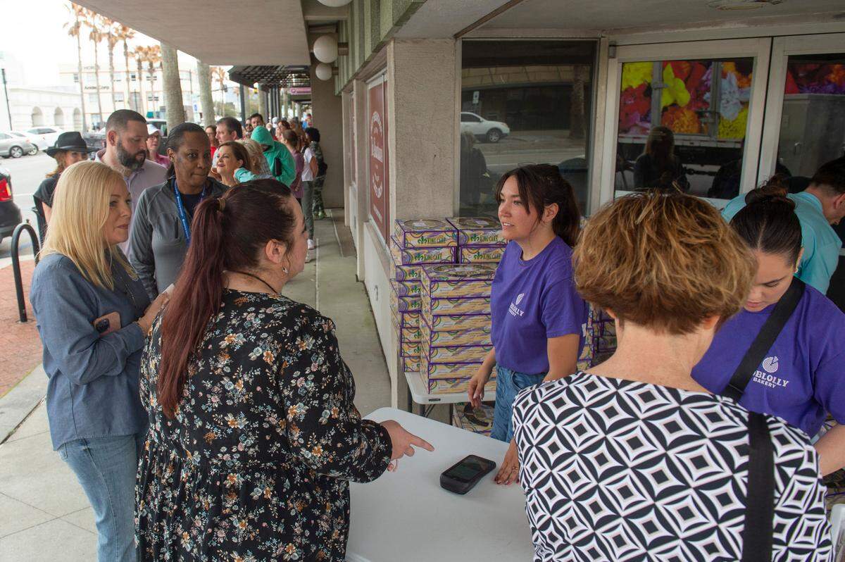 Customers line up to buy Loblolly Bakery king cakes during a pop-up sale in Gulfport on Friday, Feb. 7, 2025. The king cakes sold out in about a half-hour.