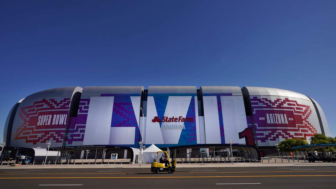 Workers prepare for the NFL Super Bowl LVII football game outside State Farm Stadium, Thursday, Feb. 2, 2023, in Glendale, Ariz. (AP Photo/Matt York)
