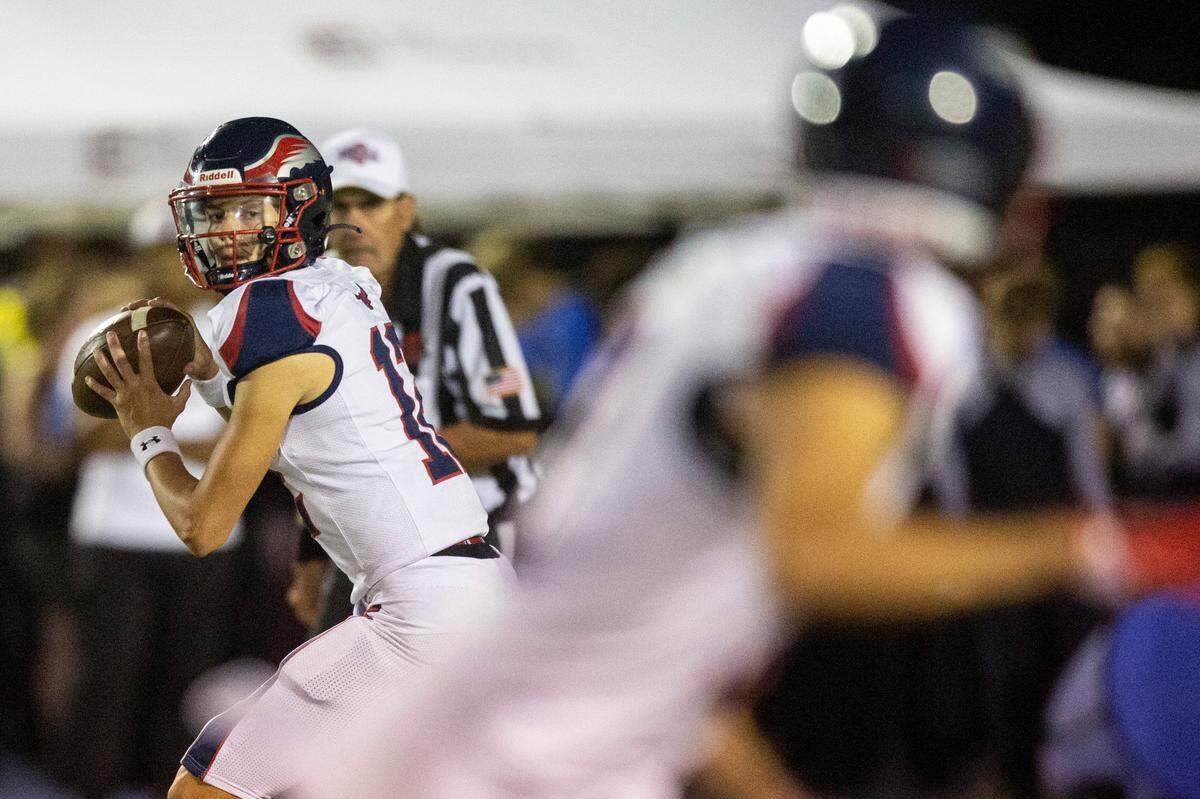 Hancock’s quarterback Dylan Moran looks to throw a pass to his teammate during a game against St. Martin at Joe Barlow Stadium in St. Martin on Friday, Sept. 30, 2022.