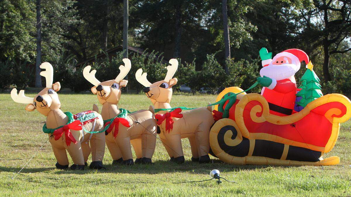 JOHN FITZHUGH/SUN HERALDDon't call them airheads -- inflatable reindeer will have no trouble pulling inflatable Santa's feather-light sleigh. They're among the Christmas decorations on Lucius Street in Biloxi on Monday.