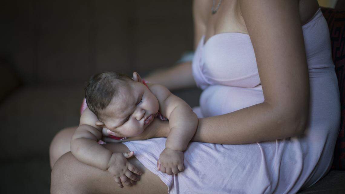 FELIPE DANA/ASSOCIATED PRESSGleyse Kelly da Silva holds her daughter Maria Giovanna as she sleeps in their house in Recife, Brazil, Wednesday.