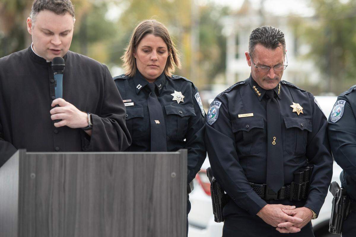 Captain Rachel Jewell and Bay St. Louis Police Chief Toby Schwartz bow their heads as a prayer is said during a ceremony dedicating commemorative stars in honor of Sergeant Steven Robin and Officer Branden Estorffe outside the new Bay St. Louis Police Department in Bay St. Louis on Thursday, Dec. 14, 2023.