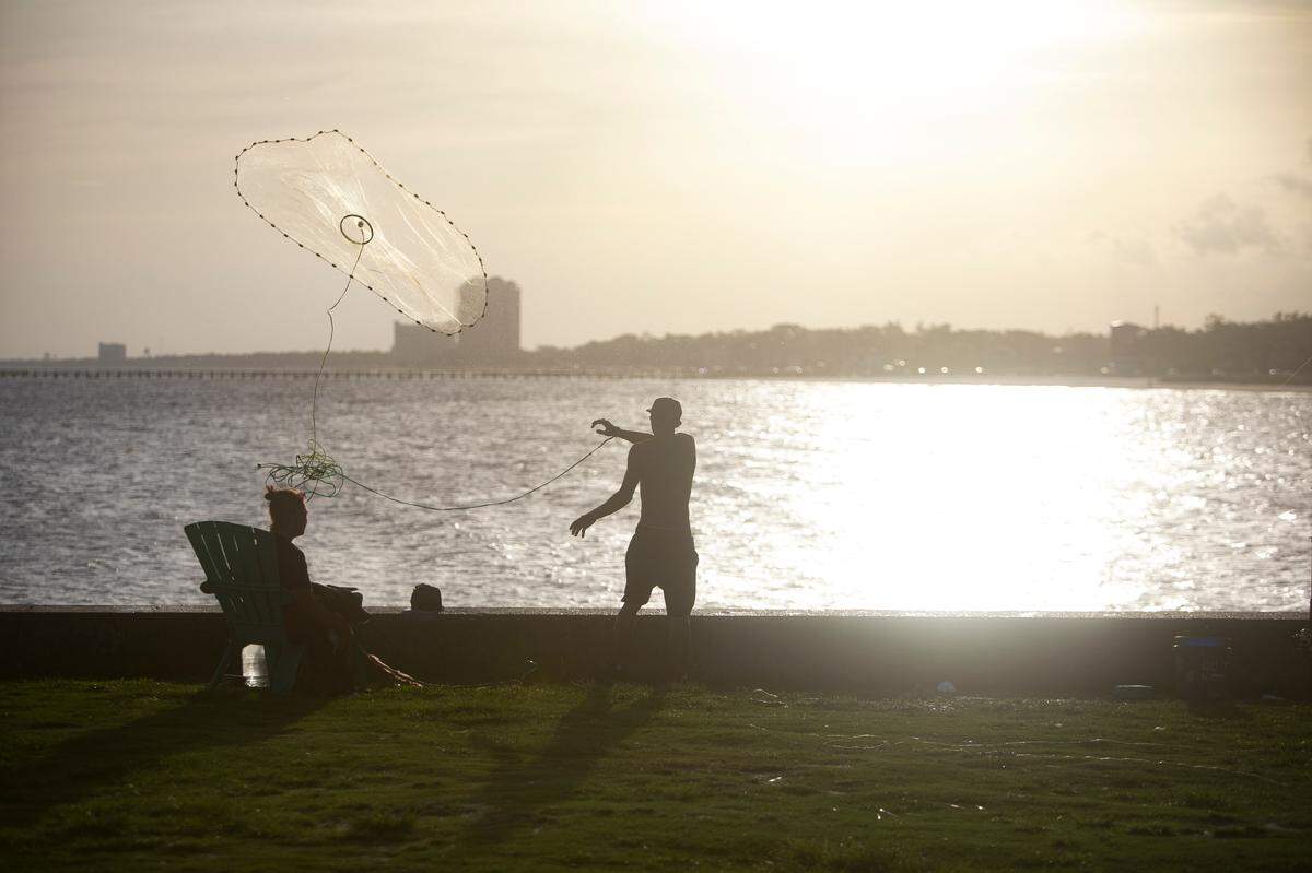 A man fishes at the Broadwater Marina in Biloxi in this 2021 file photo. The marina was damaged by Hurricane Katrina 19 years ago and is getting a $7 million restoration.