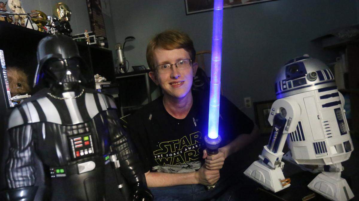 JOHN FITZHUGH/SUN HERALDBen Hart shows off with some of his 'Star Wars' memorabilia collection in Pascagoula on Friday.