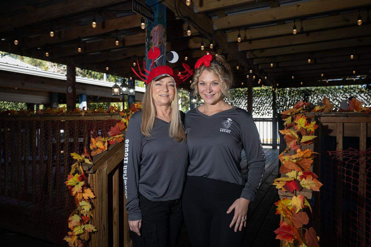 Sumer Steelman, right, and Michelle Schenck, partners at the Crawfish House and Grill in Ocean Springs, wear their signature crab hats as they talk about opening a second famly-friendly location, Crawfish House on the Bayou in Gautier.