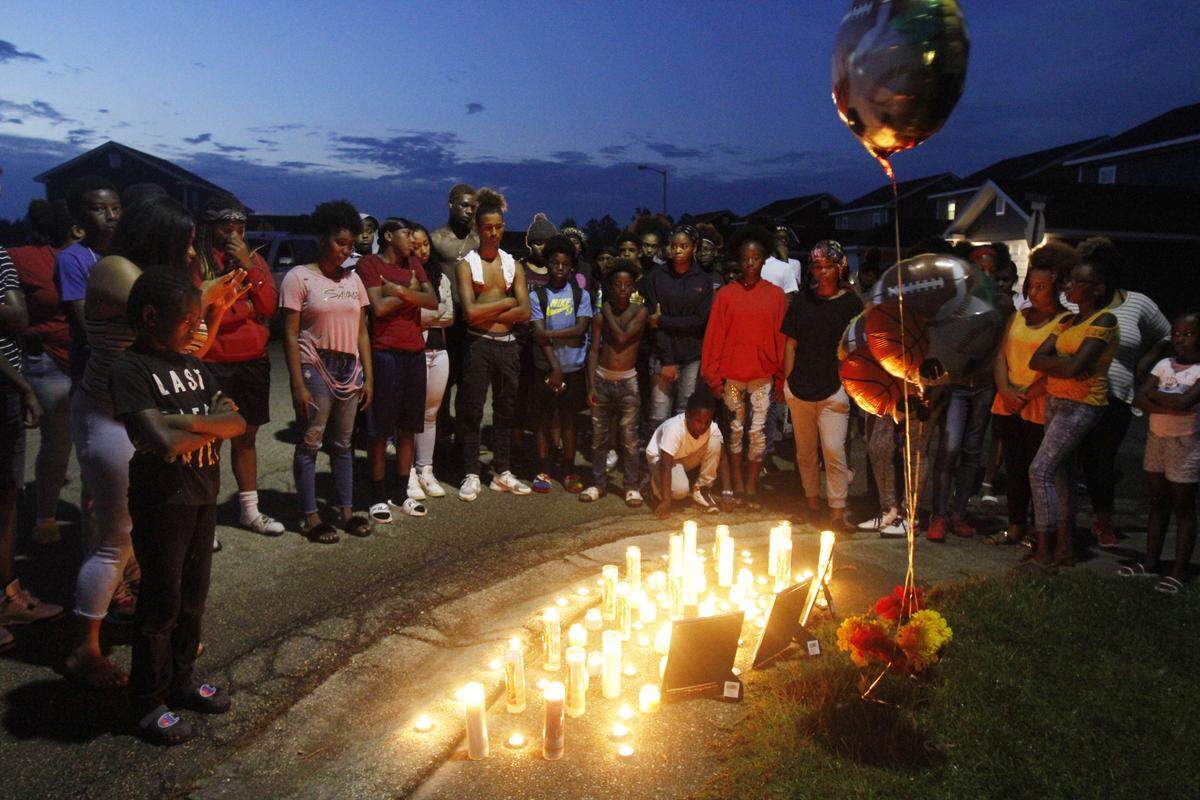 The Pelican Landing community, where Javonte Johnson, Travis Roberson Jr. and Eric Smith Jr. lived, came together Friday night to hold a candlelight vigil. The three boys drown in the Biloxi River Thursday afternoon.