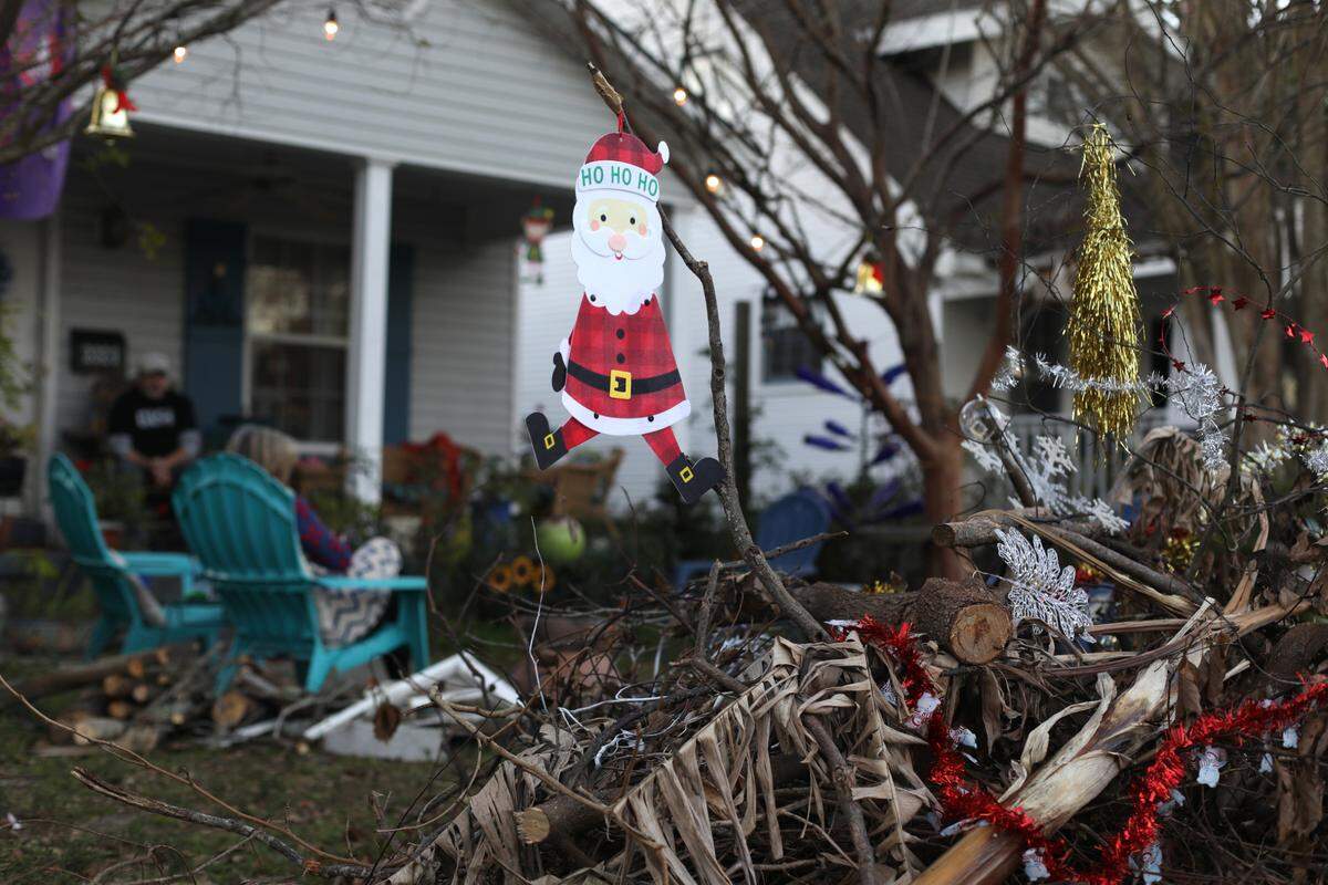 Maureen and Robert Hudson decorated a pile of debris outside of their home on Kelly Avenue in Gulfport with Christmas decorations in hopes it motivates the city to remove the pile nearly two months after Hurricane Zeta.