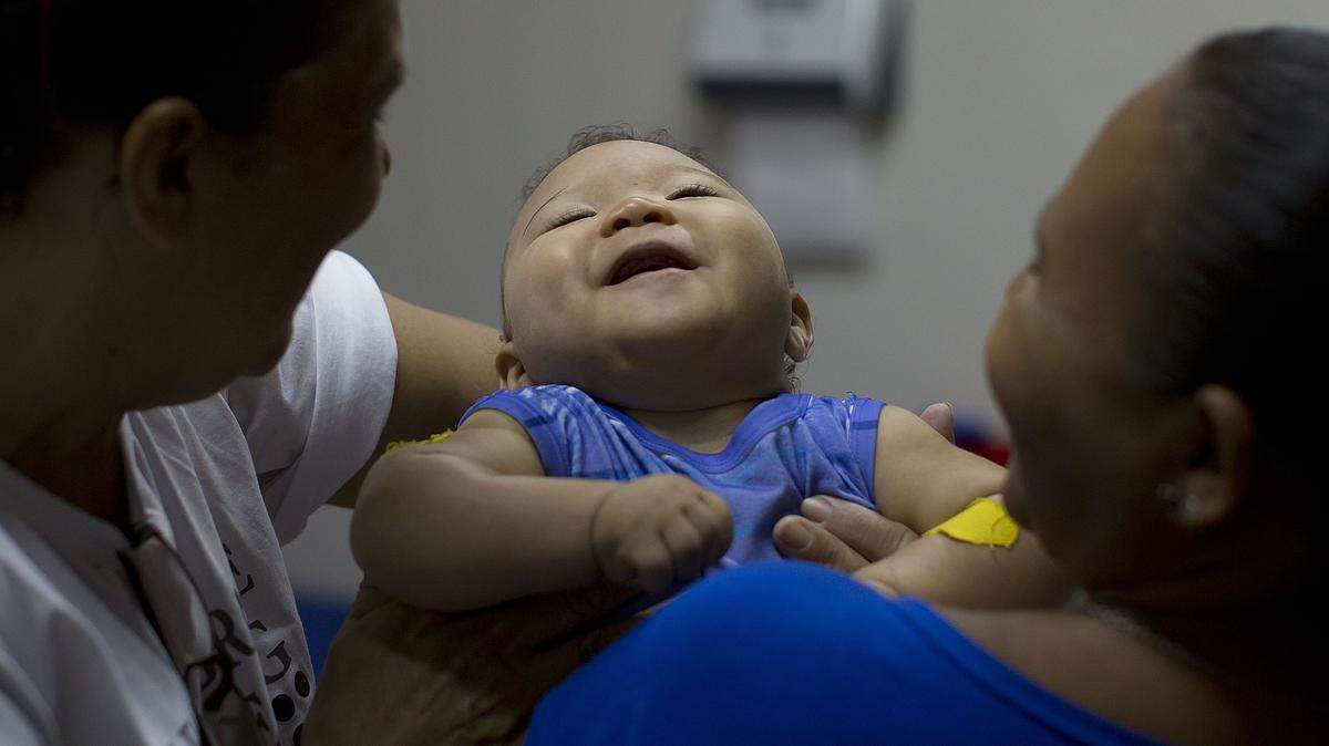 In this Thursday, Feb. 25, 2016 photo, Caio Julio Vasconcelos who was born with microcephaly, undergoes physical therapy at the Institute for the Blind in Joao Pessoa, Brazil. Researchers from the Centers of Disease Control and Prevention continue to fan out across one of Brazil's poorest states in search of mothers and infants for a study aimed at determining whether the Zika virus is causing babies to be born with unusually small heads. (AP Photo/Andre Penner)