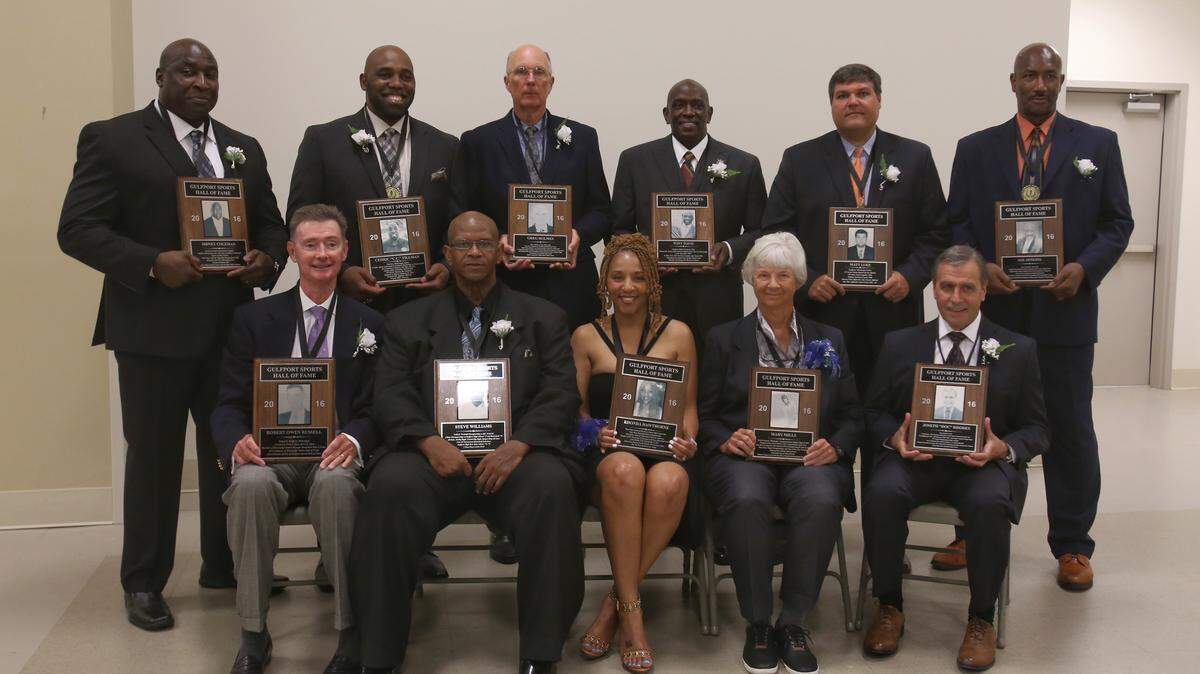 AMANDA McCOY/SUN HERALD 
 Front row, from left, Robert Russell, Steve Williams, Rhonda Hawthorne, Mary Mills, Joseph Rhodes. Back row, from left, Sidney Coleman, Cedric Tillman, Greg Holmes, Tony Davis, Matt Luke and Joe Jenkins.