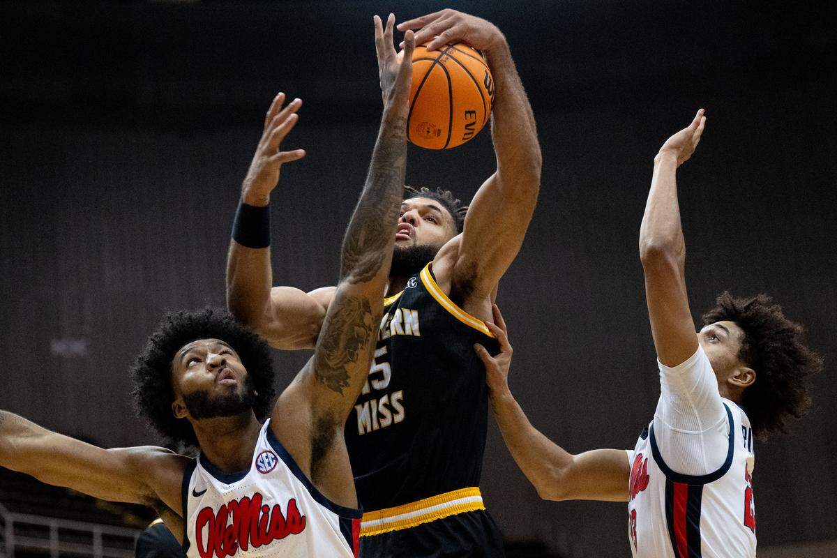 Southern Mississippi forward Djahi Binet (15) hauls in a rebound.