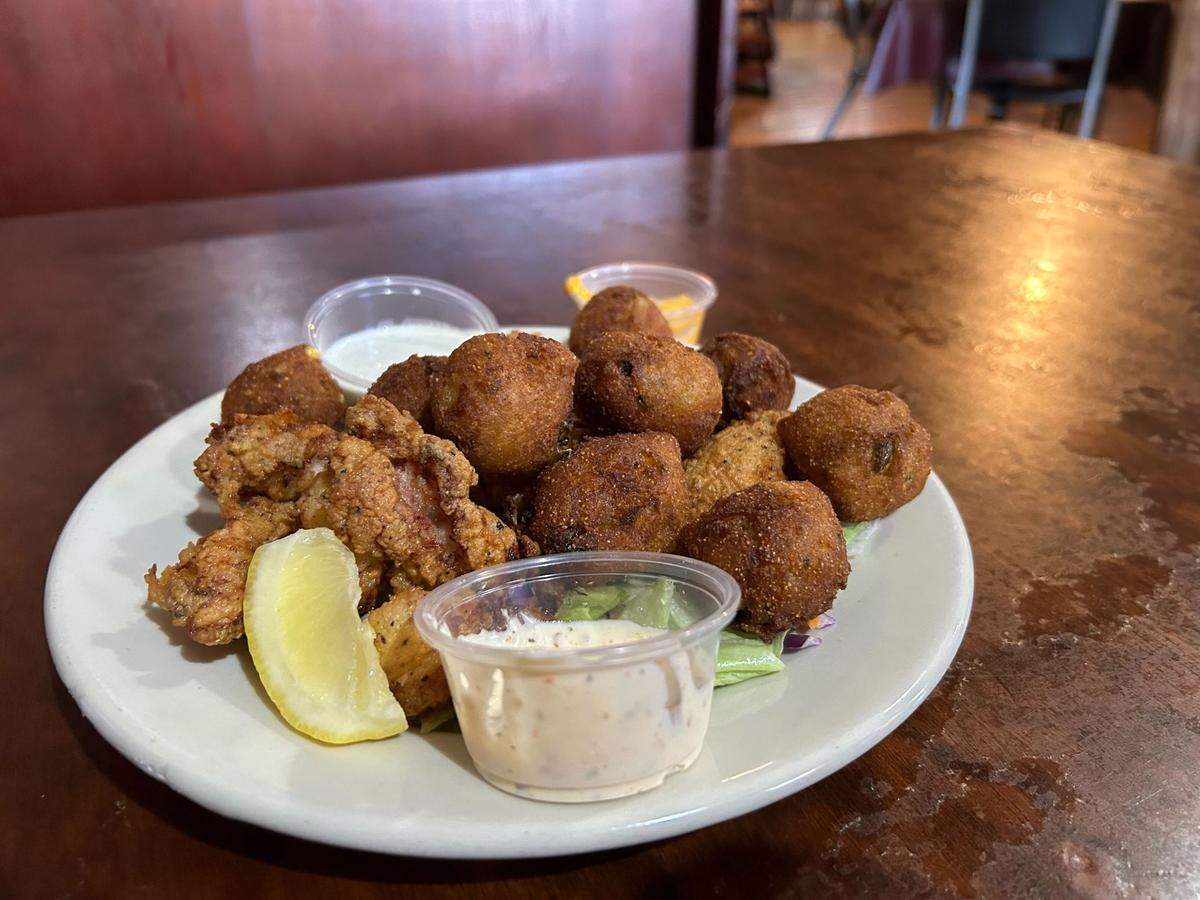The Louisiana fried alligator bites with hushpuppies at Cafe New Orleans in D’Iberville, Mississippi.