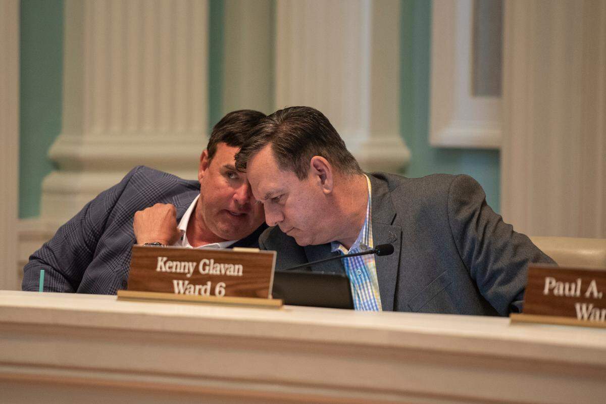City council members Nathan Barrett and Kenny Glavan talk together during a Biloxi City Council meeting at Biloxi City Hall on Tuesday, April 18, 2023 over the incidents of Black Spring Break.