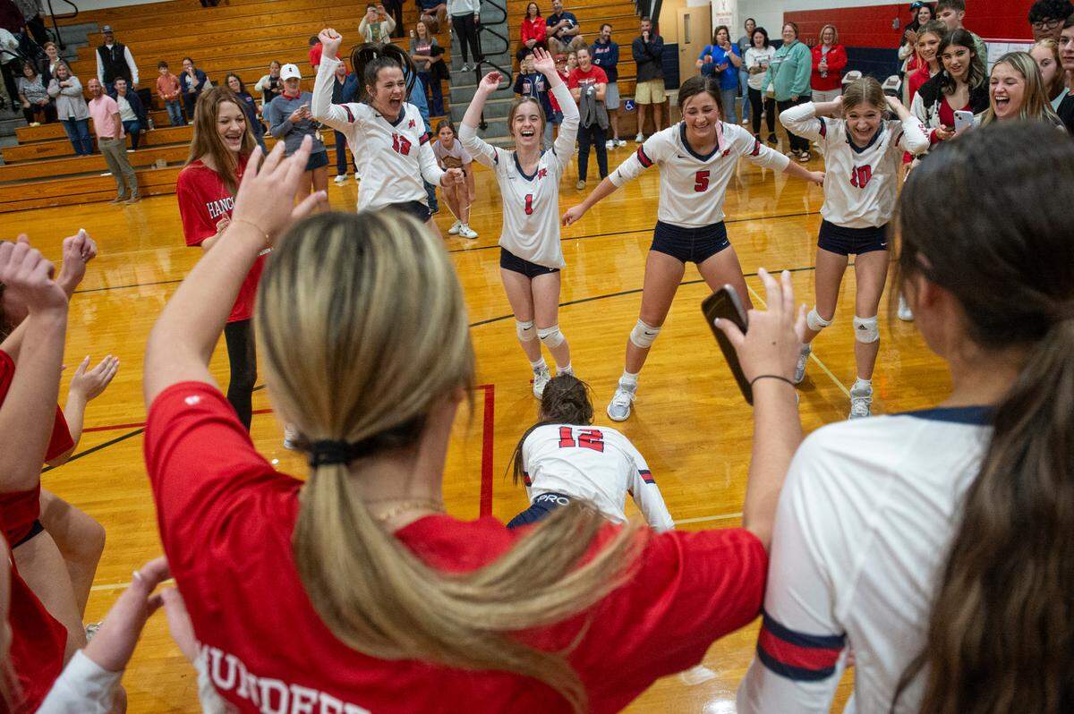 The Hancock Hawks volleyball team celebrates after winning the 6A South State Championship game at Hancock High School in Kiln on Monday, Oct. 16, 2023.