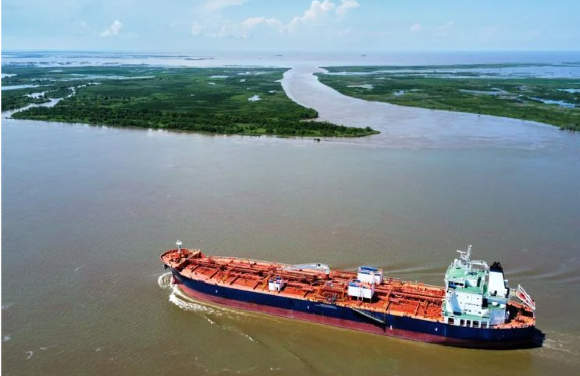 A tanker travels up the Mississippi River.