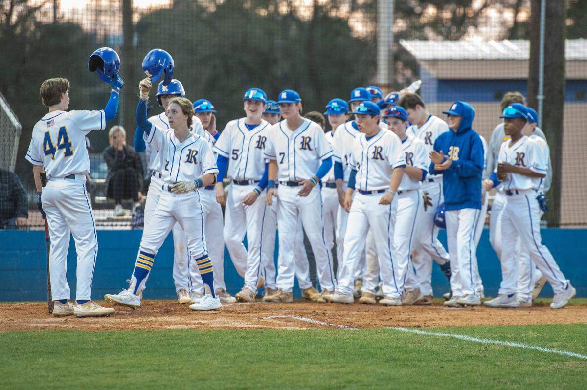 The Resurrection Eagles baseball team congratulates Walker Frederic as he runs into home base for a home run during a game against Alabama’s Bayside Academy at MCC Park in Pascagoula on Thursday, March 10, 2022.