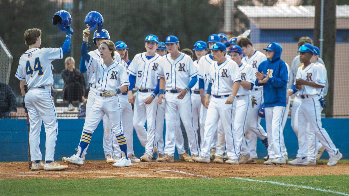 The Resurrection Eagles baseball team congratulates Walker Frederic as he runs into home base for a home run during a game against Alabama’s Bayside Academy at MCC Park in Pascagoula on Thursday, March 10, 2022.