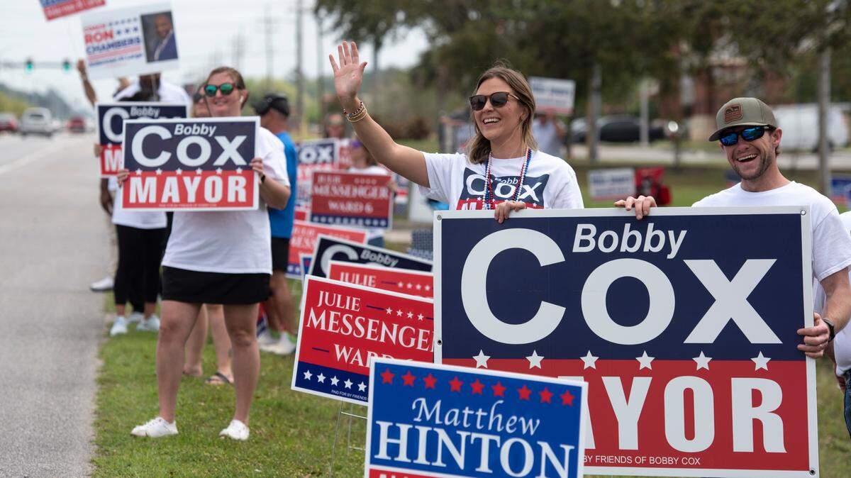 Supporters of Bobby Cox campaign from the roadside at the Civic Center in Ocean Springs during the municipal primary election on Tuesday, April 1, 2025.