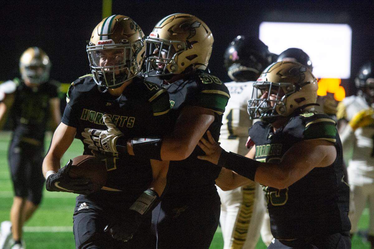 Poplarville’s Thomas Lambert and Aidan Graham celebrate after a touchdown during a playoff game between Poplarville and Mendenhall at Poplarville on Friday, Nov. 8, 2024.