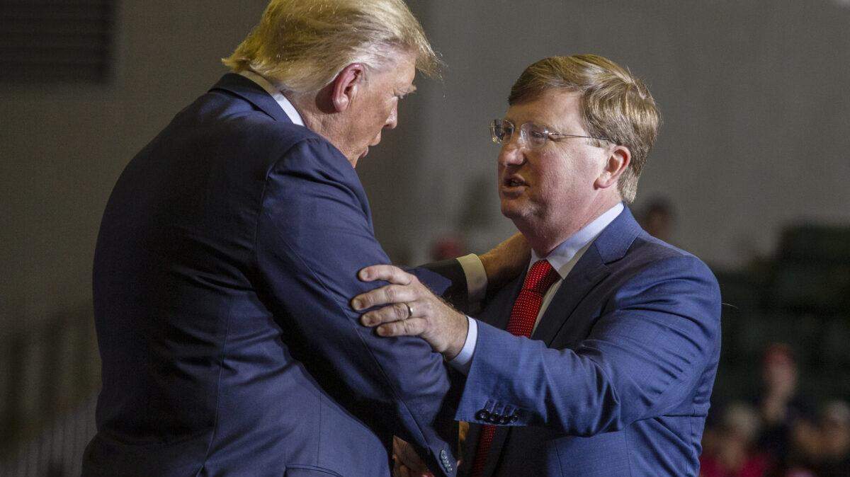 President Donald Trump embraces Lt. Gov. Tate Reeves during a 2019 campaign rally in Tupelo.