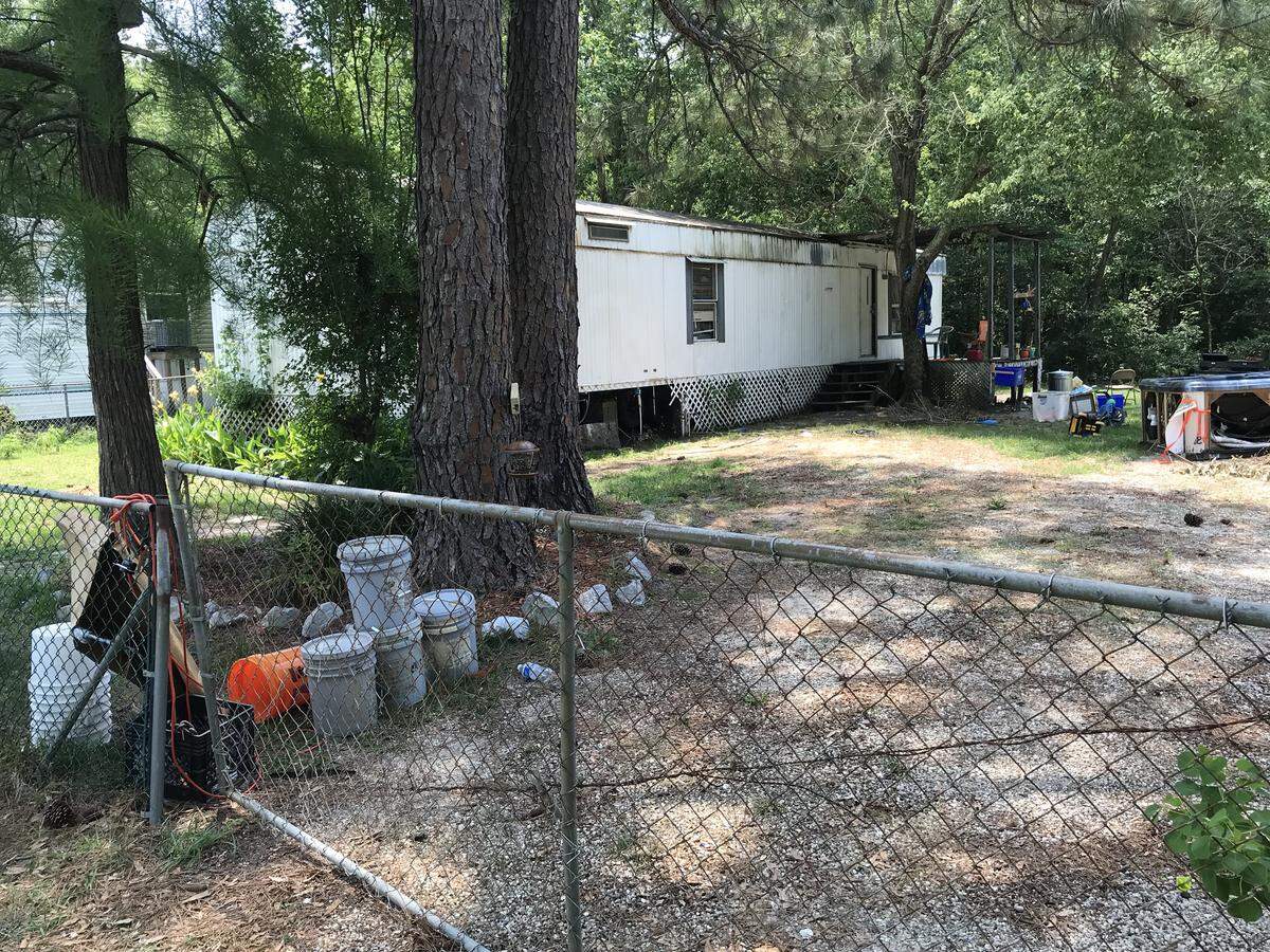 A woman was attacked and killed by two pit bulls after opening the gate to this yard on Deidra Court, Gulfport police said Wednesday. Harrison County Coroner Gary Hargrove identified her as Georgia Morgan, 75, of Gulfport, on Thursday.