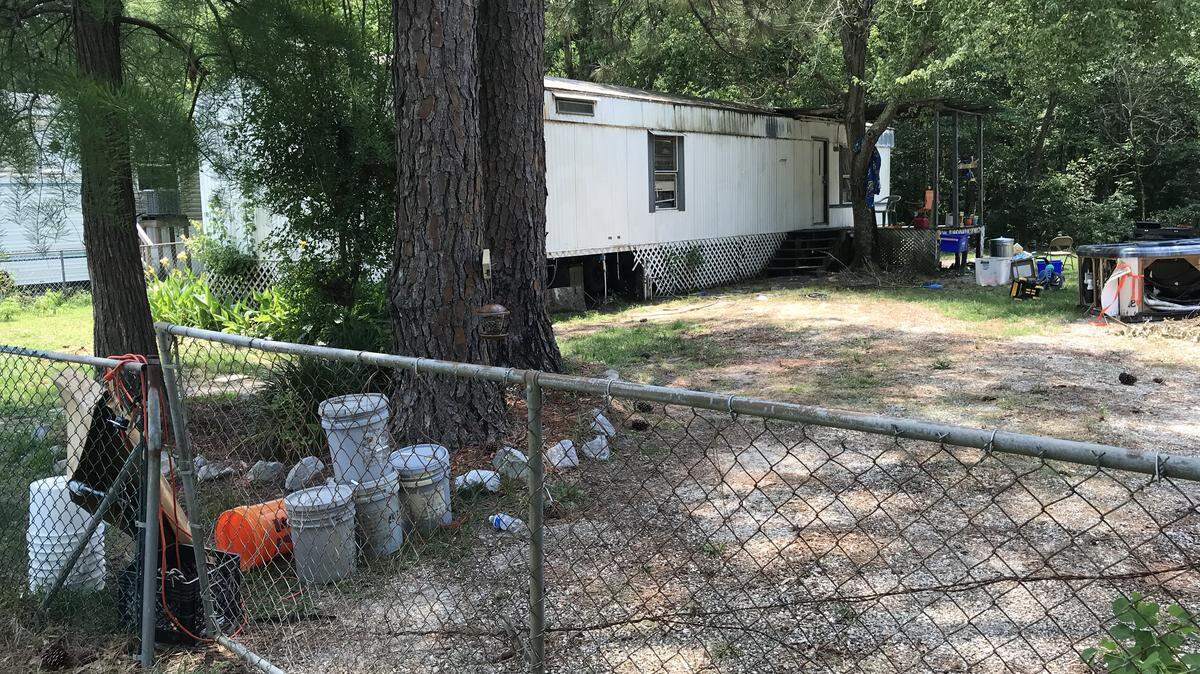 A woman was attacked and killed by two pit bulls after opening the gate to this yard on Deidra Court, Gulfport police said Wednesday. Harrison County Coroner Gary Hargrove identified her as Georgia Morgan, 75, of Gulfport, on Thursday.