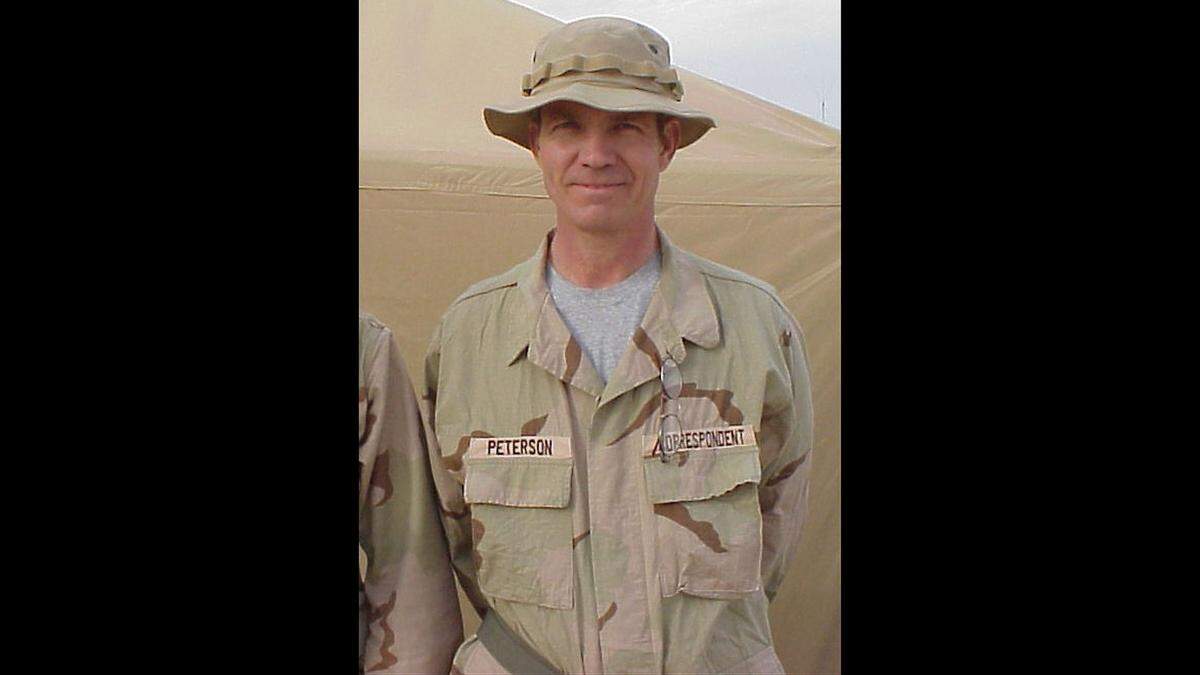 Sun Herald reporter Patrick Peterson dressed in camouflage uniform in Kuwait City, Kuwait with Marines from Coast.