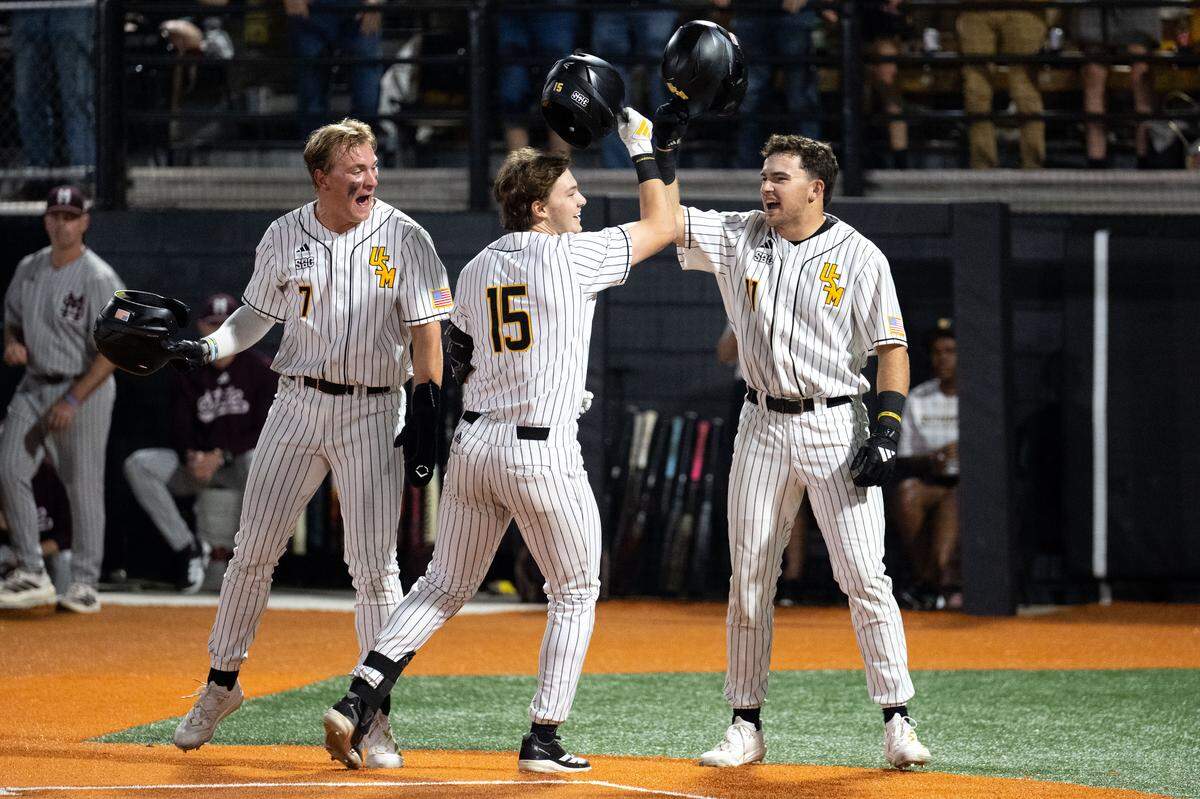 Southern Miss infielder Drey Barrett (15) celebrates scoring with outfielder Ben Higdon (7) and outfielder Davis Gillespie (11) during a baseball game at Pete Taylor Park in Hattiesburg on Tuesday, March 3, 2026.