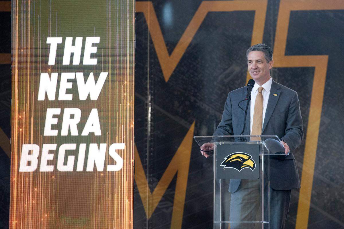 Southern Miss Athletic Director Jeremy McClain introduces new head football coach Charles Huff during a public welcome celebration for Huff at The Rock in Hattiesburg on Thursday, Dec. 12, 2024.