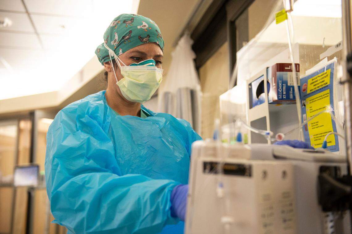 ICU nurse Jen Sartin changes settings on a patient’s IV inside the ICU at Singing River Health System hospital in Ocean Springs on Tuesday, July 27, 2021.