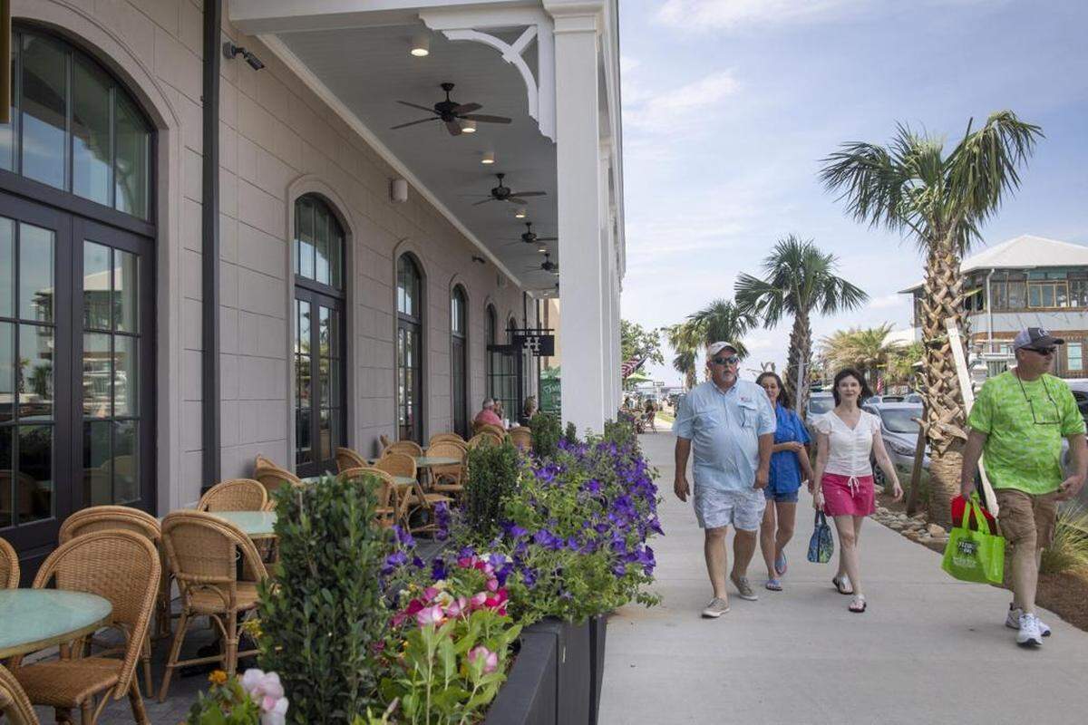 Walking down the sidewalk past the Thorny Oyster restaurant in Bay St. Louis, Mississippi on Friday, May 28, 2021. Tourism in Hancock County is surging: Revenue from taxes on hotels, motels and short-term rentals has more than doubled since 2020, and leaders are touting renewed Amtrak service as another boost.&nbsp;